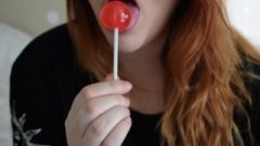 Girl With Glasses Licks Lollipop
